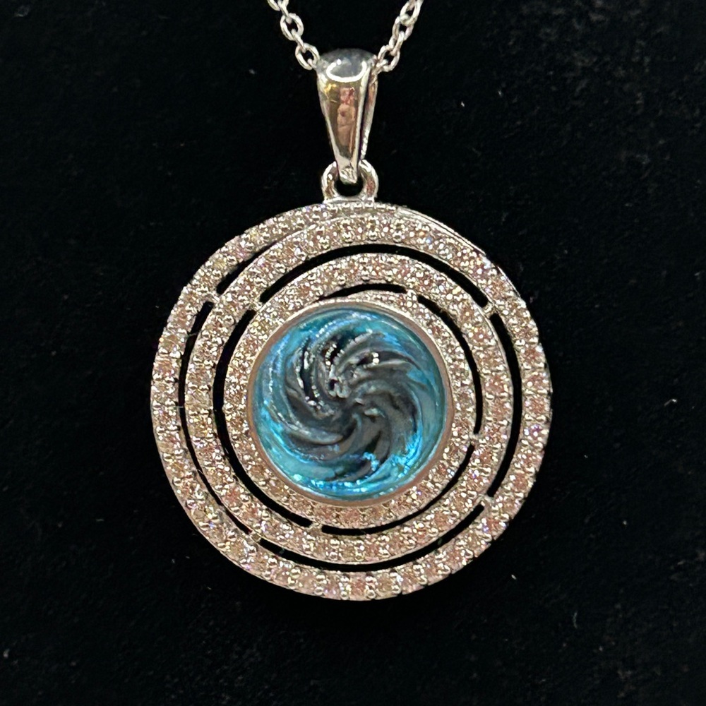 NWT Beautiful Blue pendant with swirl facet encircled by CZs. 18” chain. S925